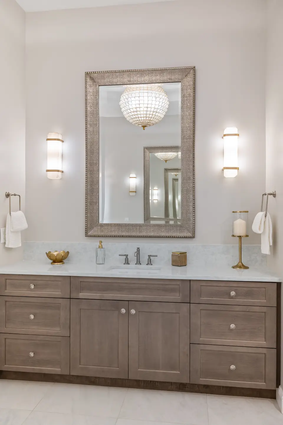Luxury primary bathroom designed by Zen Reno & Design in St. Augustine, FL, featuring statement lighting, botanical-inspired tile, custom vanities, and elegant architectural details that create a spa-like retreat.